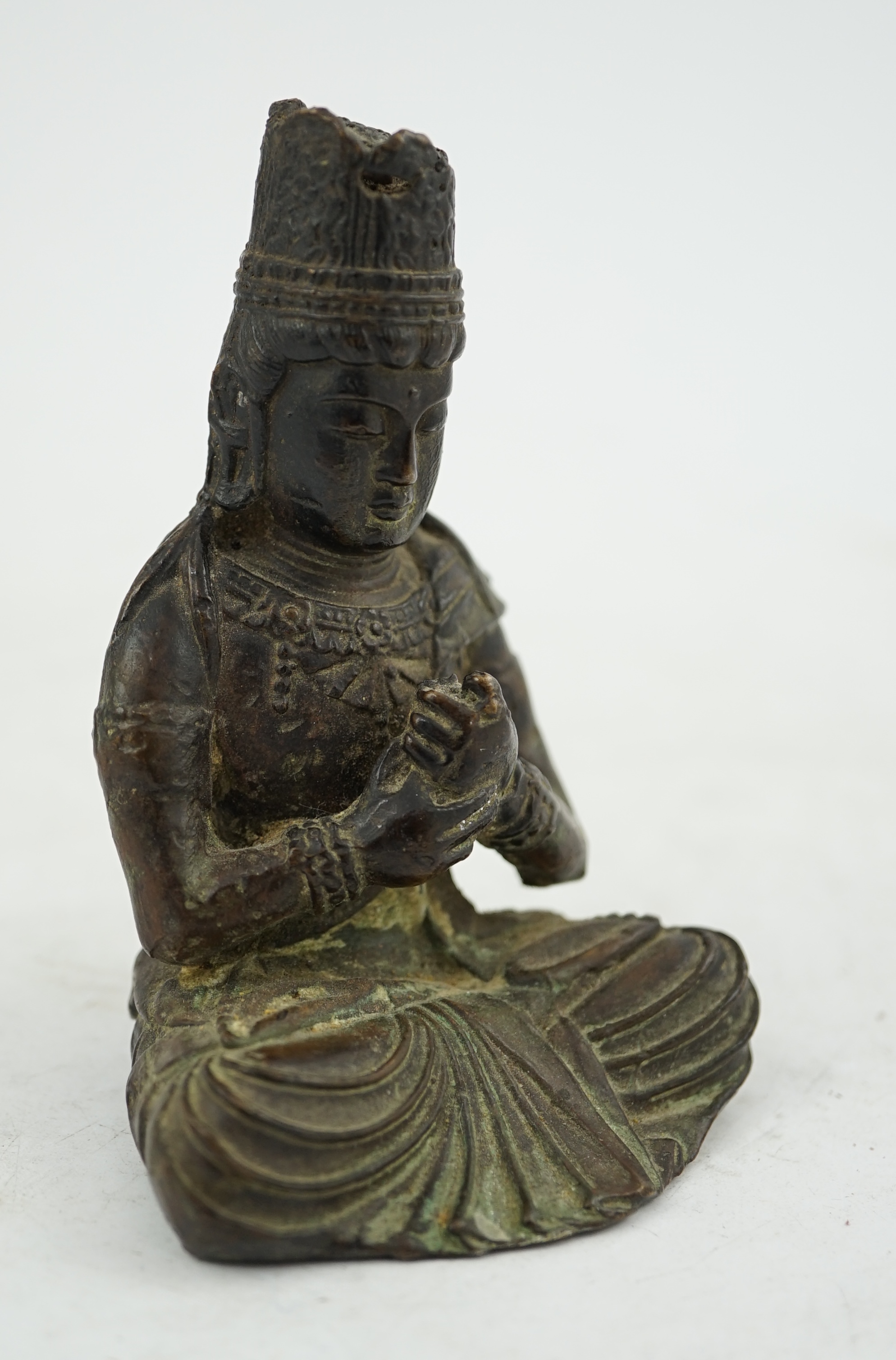 A small South East Asian bronze seated figure of Vairocana Buddha, probably 17th/18th century